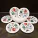 Handcrafted marble coaster with floral stone inlay on wooden table